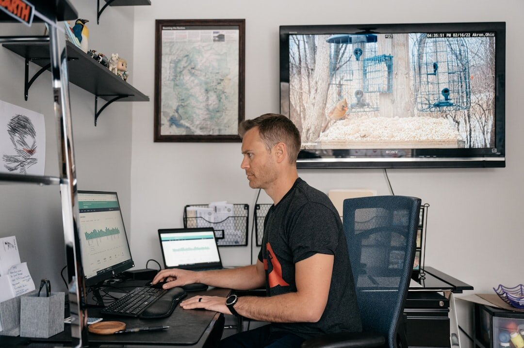 Analyst reviewing property market data on multiple computer screens