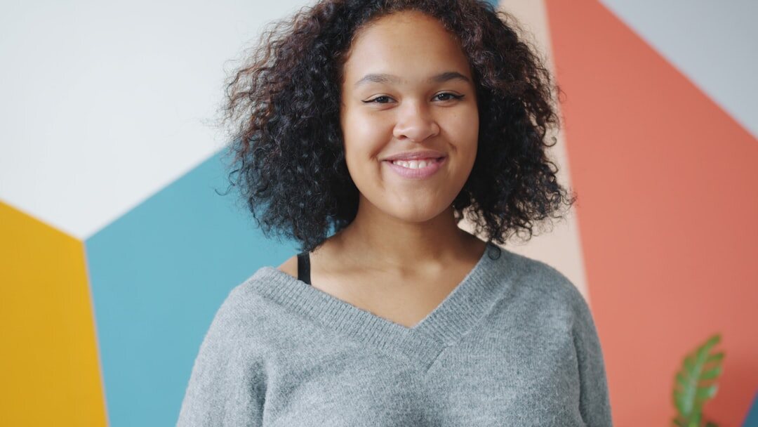 Studio portrait of a young professional woman analyst smiling